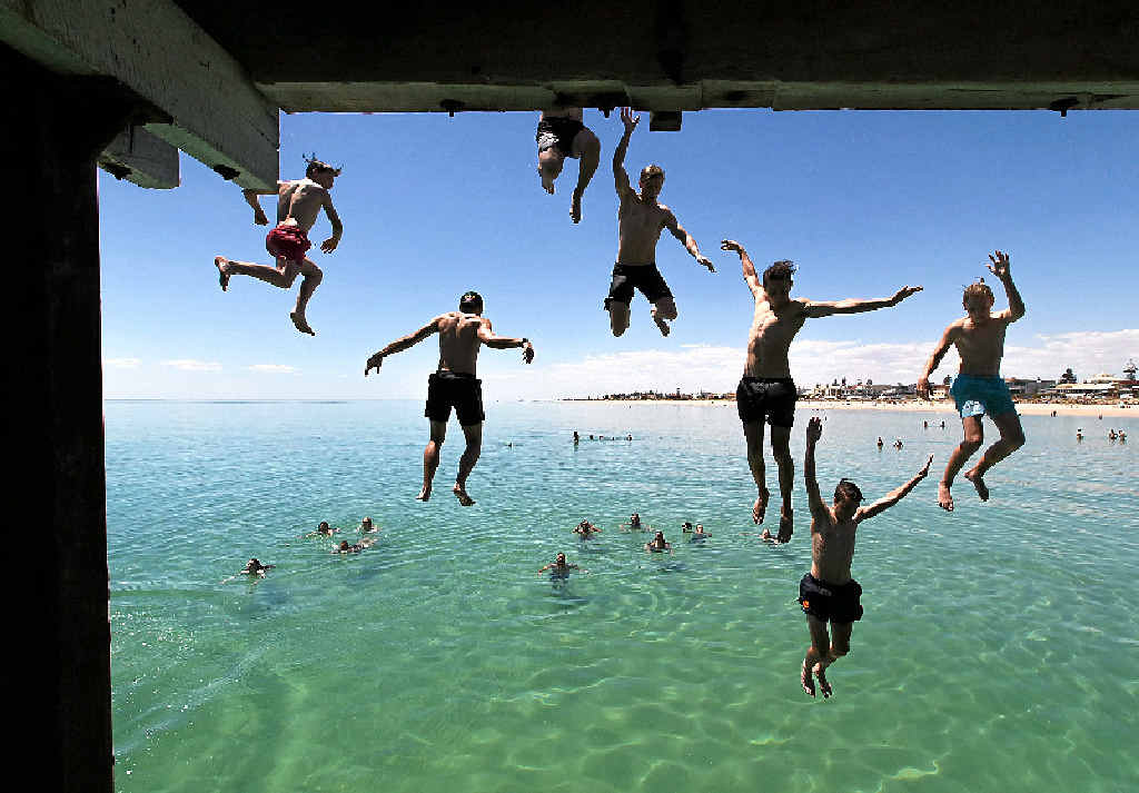 CHILL THRILLS: Jetty jumpers escape the heat at Henley Beach near Adelaide. CHILL THRILLS: Jetty jumpers escape the heat at Henley Beach near Adelaide.
